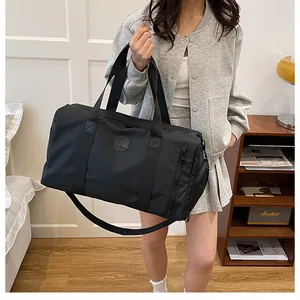 Close-up of a stylish black large capacity travel bag with dry-wet separation on a model