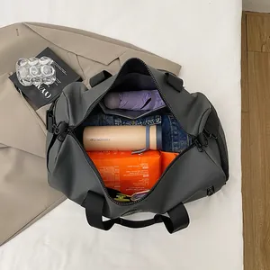 Large capacity grey gym bag with open top showing travel essentials and clothing items