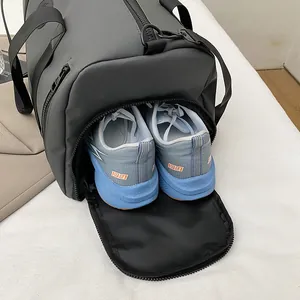 Large gray fitness duffle bag featuring a dedicated ventilated shoe compartment