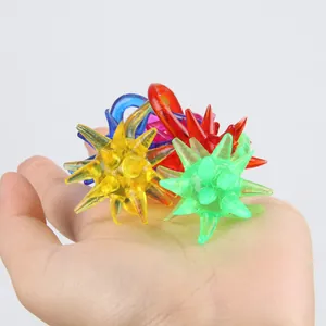 Set of colorful soft rubber sticky ball toys held in a hand showing their tactile texture