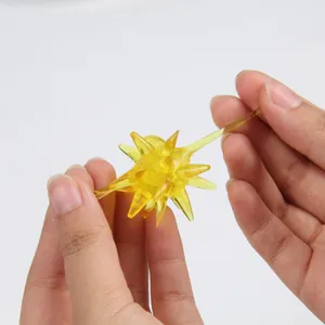 Detail showing the high elasticity and soft texture of the yellow sticky meteor hammer toy.