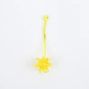 Close-up of a yellow translucent sticky morning star toy on a white background.