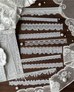 Detail view of various white ink lace PET stickers for scrapbooking and DIY crafts