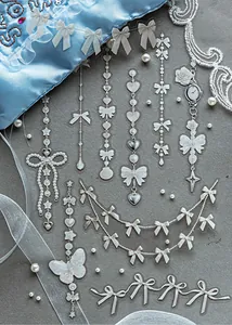 Detail of white ink PET stickers with bow and pearl motifs for scrapbooking