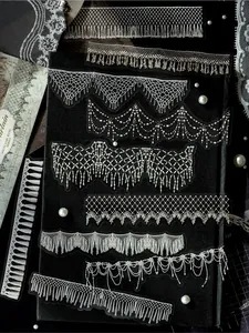 Detail of white ink PET stickers with elegant lace and tassel patterns for scrapbooking.