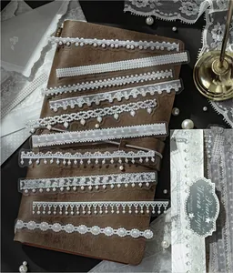 Detail showing various white lace and pearl patterns of PET long strip stickers