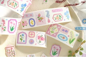 Close-up detail of vintage floral washi tape and plant stickers for creative scrapbooking
