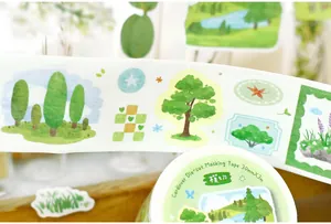 Close-up detail of nature-themed die-cut washi tape featuring green tree patterns