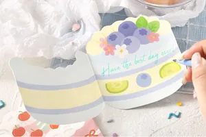 Detailed view of a cute cake shaped folding greeting card with Have the best day ever text