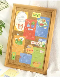 Detailed macro view of colorful illustrated DIY calendar stickers pinned to a wooden corkboard