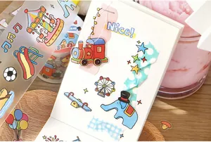 Detail of cute cartoon doodle PET tape stickers applied on a notebook for scrapbooking