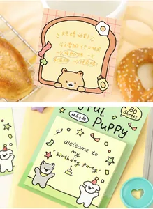 Close-up of cute cartoon puppy and toast-shaped sticky notes for bullet journaling and planners
