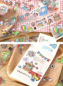 Detailed view of cute cartoon PET stickers on a notebook and washi tape roll display