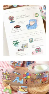 Detailed macro view of matte PET tape featuring colorful doodle illustrations on a journal page