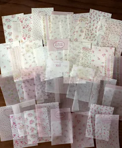 Detailed view of assorted pink floral and translucent vellum scrapbooking papers