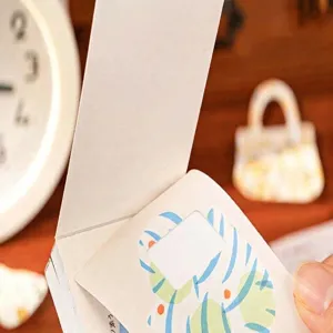 Close-up of decorative washi sticker book pages with colorful patterns for journaling.