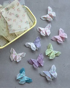 Detailed view of translucent floral material paper folded into various origami butterflies