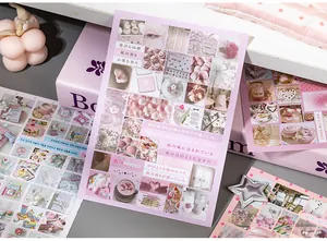 Close-up detail of aesthetic pink and purple sticker sheets for DIY scrapbooking and journals