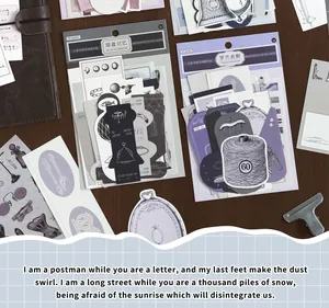 Detailed view of vintage journaling material packs featuring thread and frame stickers