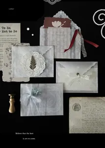 Detailed view of elegant translucent lace vellum envelopes with vintage ribbon accents