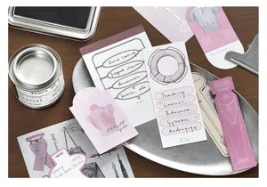 Close-up of retro style junk journal ephemera pack with aesthetic paper tags and stickers.