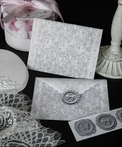 Detail view of elegant translucent lace vellum envelopes with decorative grey wax seal stickers.