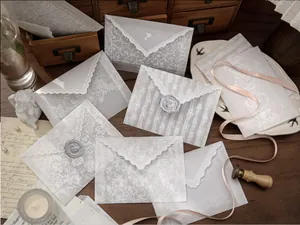 Elegant vellum envelope set with intricate white lace patterns and wax seal details.