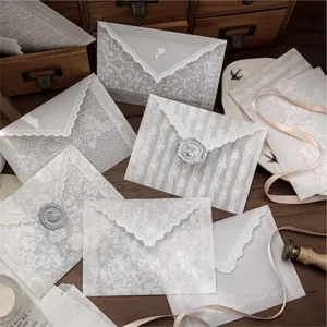 Vintage translucent vellum envelopes with elegant white lace patterns for letters