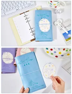 Detailed view of light blue A6 loose-leaf notebook with elegant embossed lettering