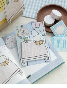 Detail view of MO·CARD Tired Kitten sticky notes on a decorative notebook