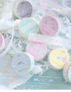 Detailed view of decorative PET tape rolls with floral and dolphin themes for journaling