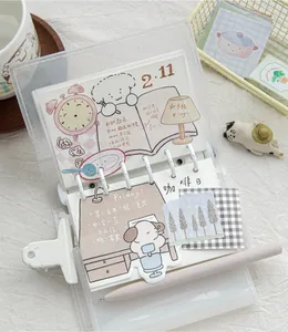 Detailed view of cute illustrated sticky notes used in a creative lifestyle planner binder