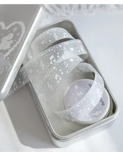Detail view of translucent glitter PET tape with musical note and pixel heart patterns.