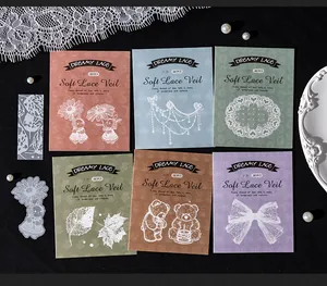 Close-up of various "Soft Lace Veil" vintage sticker packs on dark background.