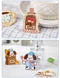 Close-up view of cute cartoon dog and fireplace embroidered patches for DIY clothing