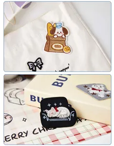 Close-up detail of cute bakery dog and sleeping cat embroidered patches on canvas bag