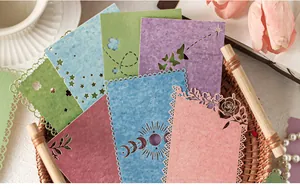 Detailed view of laser-cut colorful textured scrapbooking paper in a wicker basket