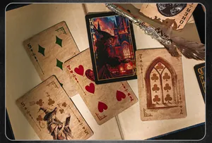 Close-up of vintage magic city themed playing cards with an ornate feather pen
