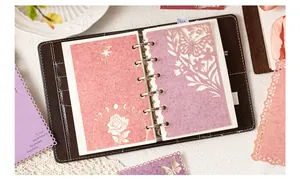 Detail view of intricate laser-cut decorative papers inside a brown leather journal