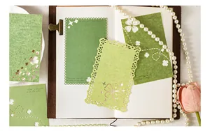 Detailed view of green laser-cut decorative paper for scrapbooking and journaling.