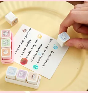 Close-up of modular bullet journal stamps with lifestyle icons and handwritten daily notes