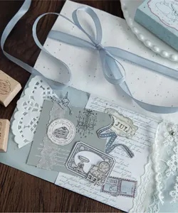 Close-up of vintage beechwood stamps and creative journaling collage with ribbon