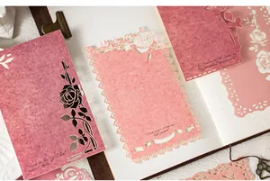 Detailed view of laser-cut floral scrapbook paper with inspirational quotes.
