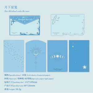 Close-up of celestial blue material paper set with star and moon patterns for journaling