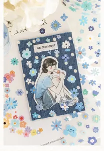 Detailed view of salt-style floral stickers applied on denim for DIY journal decoration