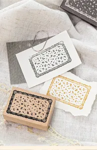 Vintage beech wood stamp with a detailed lace border design for creative DIY journaling.