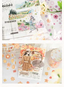 Detailed macro view of decorative floral washi tape and stickers on a scrapbook card.
