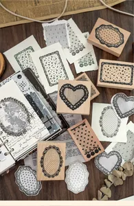 Detailed view of assorted beechwood lace border stamps on a vintage journal page