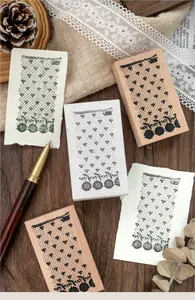 Detail of vintage lace pattern wooden stamps and their ink impressions on paper