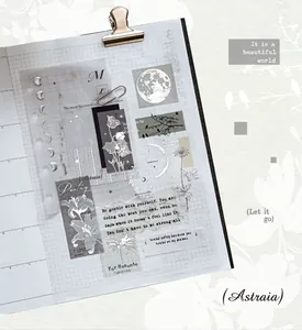 Close-up of silver-stamped vintage washi tape and stickers for journaling.